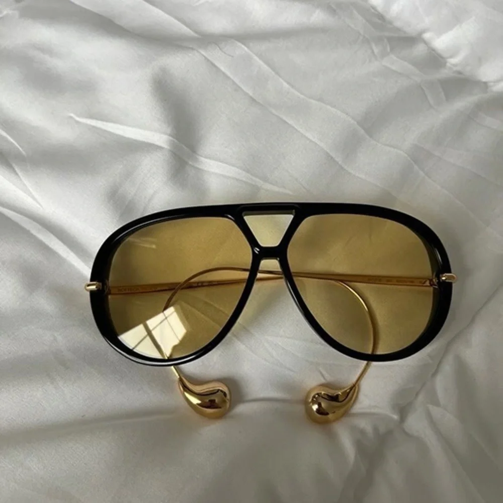 Bottega Veneta Black Frame Sunglasses with Yellow Lenses